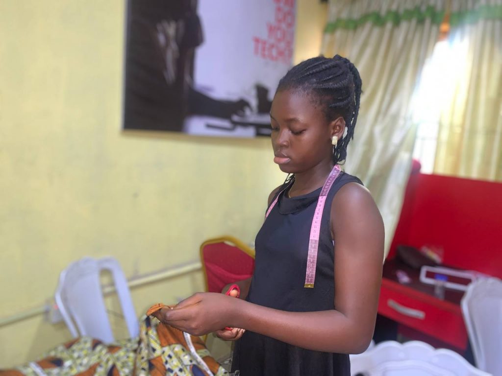 Michelle Job cutting up fabric at Uwani Hub