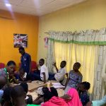 Oluwakemi teaching the teenagers.